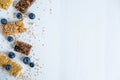 Banner with blueberries and energy bars on a white wooden background. Blueberry granola and berries with a place for inscription Royalty Free Stock Photo