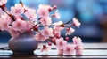 Banner with a branch of pink sakura in a vase over water, on a background with bokeh. Copy space Royalty Free Stock Photo