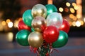 Banner with a bunch of red, green and gold helium balloons on a background of bokeh lights Royalty Free Stock Photo