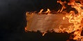 a banner,a burning piece of crumpled beige old paper on a black background,the concept of creative graphic and web design,fire