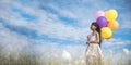 Banner Cheerful cute girl holding balloons running green meadow white cloud and blue sky with happiness. Panorama Hands holding