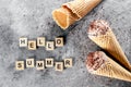 Banner. Chocolate ice cream in waffle cones, text Hello Summer on concrete gray background. Top view