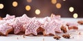 Banner of Christmas gingerbread cookies adorned with sweet pink icing and anise stars. bokeh lights in background Royalty Free Stock Photo