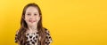 Banner. Close-up portrait of smiling teenage girl on yellow background, copy space Royalty Free Stock Photo