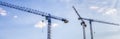 Construction tower cranes with cabins in a blue sky. Industry concept Royalty Free Stock Photo