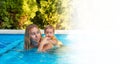 Banner with copy space. Portrait of young woman instructor swimming in the pool with her little girl. Learning to swim Royalty Free Stock Photo