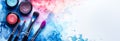 Banner with cosmetics: makeup eyeshadows palette and brushes on a white background with blue and pink watercolor splashes