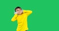 Banner. Cute boy in big headphones smiles and poses against a green background with side space.