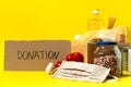 Banner.Donation. Food supplies crisis food stock for quarantine isolation period on yellow background. Rice, peas Royalty Free Stock Photo