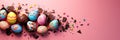 Banner with easter painted eggs in broken chocolate eggshell on pink background Royalty Free Stock Photo