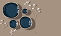 A banner with empty dark blue plates highlighted on a light tablecloth with dried flowers. Clay plates of different Royalty Free Stock Photo