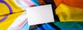 Banner Empty paper blank on Rainbow LGBTQIA flag made from silk material. Mock up template copy space for your text