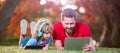 Banner of father on son school boy with laptop study online lying on grass, childhood and parenthood. happy boy listen Royalty Free Stock Photo