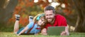 Banner of father on son school boy with laptop study online lying on grass, happy family of dad and son use laptop for Royalty Free Stock Photo