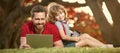 Banner of father on son school boy with laptop study online lying on grass, happy family of dad and son use laptop for Royalty Free Stock Photo