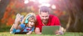 Banner of father on son school boy with laptop study online lying on grass, happy family of father and son use laptop Royalty Free Stock Photo