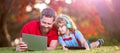 Banner of father on son school boy with laptop study online lying on grass, happy family of father and son use laptop Royalty Free Stock Photo