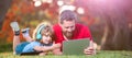 Banner of father on son school boy with laptop study online lying on grass, happy family of father and son use laptop Royalty Free Stock Photo