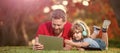 Banner of father on son school boy with laptop study online lying on grass, happy family of father and son use laptop Royalty Free Stock Photo