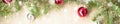 Banner of Festive christmas border with red balls on fir branches and snowflakes with snow on rustic beige background Royalty Free Stock Photo