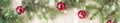 banner of Festive christmas border with red balls on fir branches and snowflakes with snow on rustic beige background Royalty Free Stock Photo