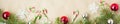 Banner of Festive christmas border with red and silver balls on fir branches and snowflakes on rustic beige background Royalty Free Stock Photo