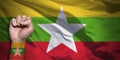 Banner of Flag of Myanmar Burma painted on male fist, fist flag, country of Myanmar, strength, power, concept of conflict