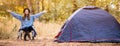 Banner format photo of camping holiday, tourist traveler woman with hands up in sweater and black hat ralaxing in camp tent in