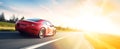 Banner of a generic and unbranded red sport car running in sunset, ai generative illustration Royalty Free Stock Photo