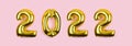 2022 banner with golden foil balloons on pink background. Numbers 2022 gold balloons on pink wall . New Year's card Royalty Free Stock Photo