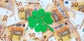Banner with green felt four leaf clover on fifty euro banknotes background. Lucky talisman. Saint Patricks day.