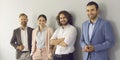 Group portrait of happy confident business people standing against studio background Royalty Free Stock Photo