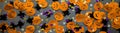 Banner Halloween background: shiny confetti in the shape of orange pumpkins, black spiders and colorful stars green, purple color Royalty Free Stock Photo