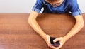 Banner Hands of a boy using a mobile phone on the table at school on a white background Modern mobile and communications