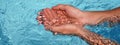 Banner the hands cupped together submerged in clean clear blue water in swimming pool Royalty Free Stock Photo