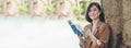 Banner Happy asian woman reading book outdoor in green park. Panorama Reading book magazine relaxation woman. Leisure portrait