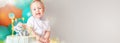 Banner of happy little boy (1 year old) with birthday cake (sweets with candles of number one, decoration). Royalty Free Stock Photo