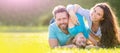 Banner of Happy family Lying on grass. Young mother and father with child son in the park resting together on the green Royalty Free Stock Photo