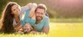 Banner of Happy family Lying on grass. Young mother and father with child son in the park resting together on the green Royalty Free Stock Photo