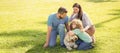 Banner of Happy family Lying on grass. Young mother and father with child son play with dog in the park resting together Royalty Free Stock Photo