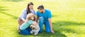 Banner of Happy family Lying on grass. Young mother and father with child son play with dog in the park resting together Royalty Free Stock Photo