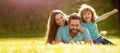Banner of Happy family Lying on grass. Young mother and father with child son play in the park resting together on the Royalty Free Stock Photo