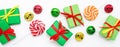 Banner Happy holidays: gifts with lollipops and red, green, golden bells on a white background. The concept of Christmas, sales, Royalty Free Stock Photo