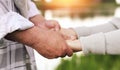 Banner with a happy mature couple holding hands against the background of a beautiful sunset on the lake close-up. ÃÅ¾ld age, Royalty Free Stock Photo