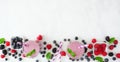 Banner with healthy mixed berry smoothie bottom border over a white marble background with copy space