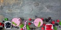 Banner with healthy mixed berry smoothie bottom border, top view over a dark stone background