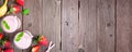 Banner with healthy strawberry banana smoothie corner border over a rustic wood background with copy space Royalty Free Stock Photo