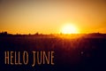 Banner hello june. Text on the photo. Text hello June. New month. New season. Summer month. Text on sunset photo Royalty Free Stock Photo