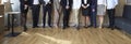 Banner image of legs of different business people standing in row in modern loft office.