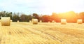 Banner with landscape of a mown wheat field at sunset with huge haystacks. Summer. Agriculture. Harvesting. Bakery production. Royalty Free Stock Photo